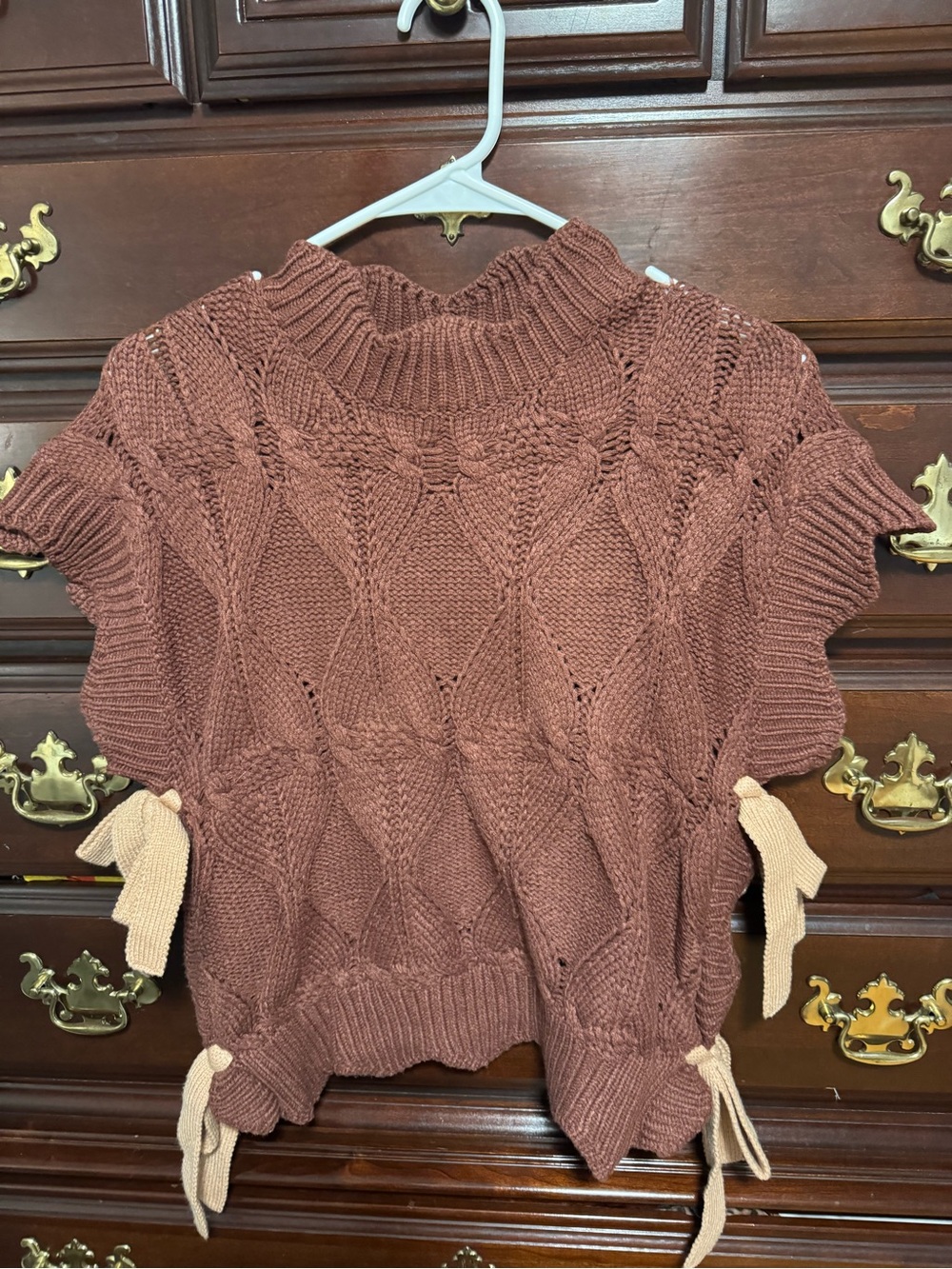 Brown cable knit sweater vest with bows